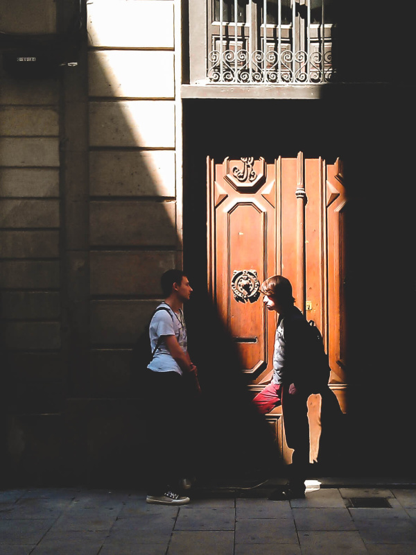 Barcelona, shadow game, sharp triangle light, young man talking