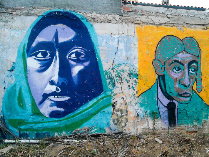 Barcelona, blue face woman, green headscarf, street art mural