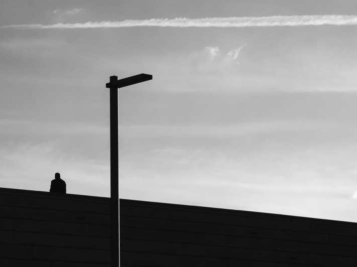 Barcelona, black and white, lonely man, outdoor stairs, silhouette sitting, street lamp, urban melancholy architecture