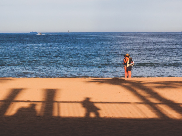 Barcelona beach kiss, palm tree, sunset silhouette, young couple