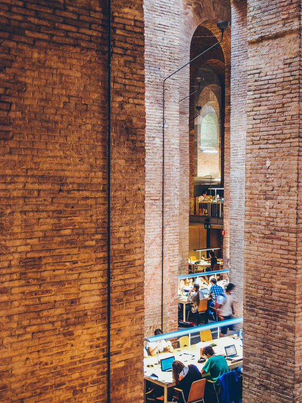 Barcelona, high brick walls, les aigues library, students working, water reservoir