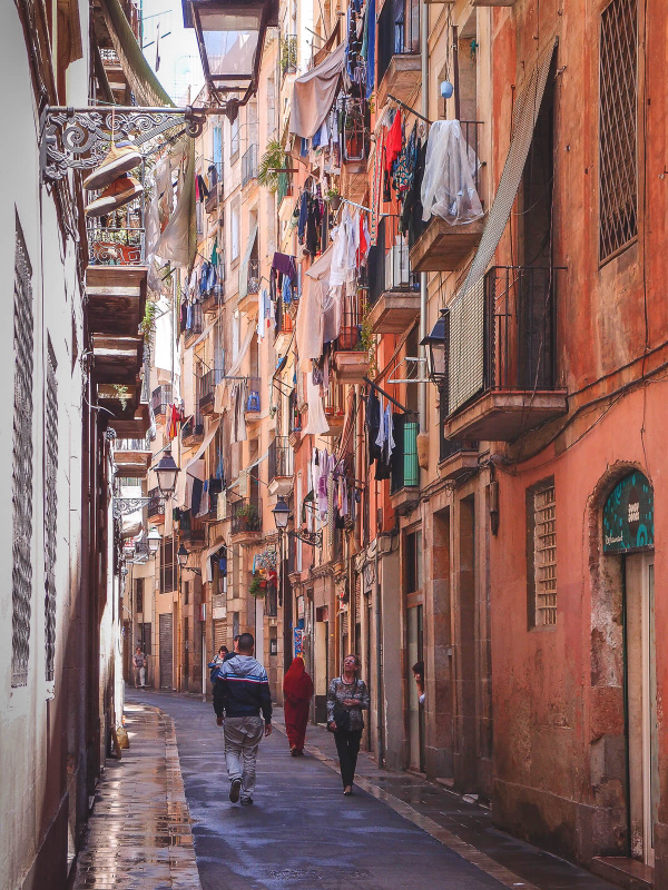 Barcelona, cloths dry outside, narrow alley streets, old town, pedestriants walking, streetlife