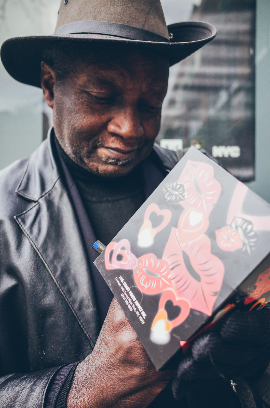 Luis Mendes signing a polaroid picture he made in New York City